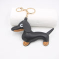 Load image into Gallery viewer, Black faux leather sausage dog keychain displayed on a white background