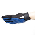 Load image into Gallery viewer, Side view showing flexible mesh and rubber tips on blue glove worn on hand