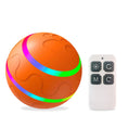 Load image into Gallery viewer, Orange intelligent cat ball with paw print design and LED light strips next to a white remote control