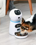 Load image into Gallery viewer, Pet feeder dispensing food into stainless steel bowl while a dog eats on wooden floor