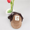 Charger l'image dans la visionneuse de la galerie, Close-up of a brown corduroy and mesh dog hat with embroidered G displayed in front of a flower pot