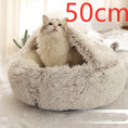 Load image into Gallery viewer, Cat sitting inside beige plush dome bed labeled 50 cm size