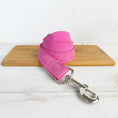 Load image into Gallery viewer, Close-up of pink velvet leash with metal clip on wooden board