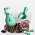 Load image into Gallery viewer, Kitten wearing turquoise silicone nail covers while being examined by a vet