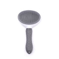 Load image into Gallery viewer, Top view of a grey and white detachable pet grooming brush with metal bristles