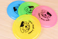 Load image into Gallery viewer, Four colorful dog flying discs with dog and bone design on wooden surface