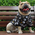 Load image into Gallery viewer, Happy French Bulldog wearing black jumper with circular graphic prints sitting on wooden bench