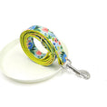 Load image into Gallery viewer, Rolled floral dog leash arranged on white ceramic plate