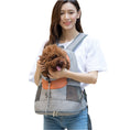 Load image into Gallery viewer, Woman happily holding dog’s head coming out of orange and gray backpack pet carrier