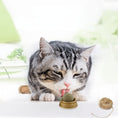 Load image into Gallery viewer, Gray and white cat licking catnip ball mounted on brown plastic base with twine balls in background