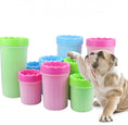 Load image into Gallery viewer, Multiple silicone dog paw washers in pink, blue, and green with a pug dog lifting paw