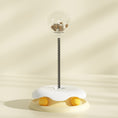 Load image into Gallery viewer, Beige interactive cat treat toy with clear treat container and spring stem on soft beige background