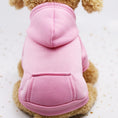 Cargar la imagen en la vista de la galería, Small dog wearing a pink fleece hoodie with hood and back pocket sitting against a white background