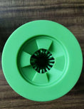 Load image into Gallery viewer, Top view of green silicone dog paw washer showing the flexible bristles opening