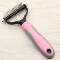 Load image into Gallery viewer, Pink and grey handled dog grooming comb resting on wooden surface