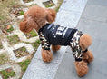Load image into Gallery viewer, Apricot toy poodle walking outdoors on sidewalk wearing camo FBI dog jumpsuit viewed from above