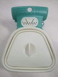 Load image into Gallery viewer, Close-up of teal and white dog poop spoon dispenser showing handle and folding details