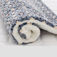 Load image into Gallery viewer, Rolled plush pet blanket with navy and beige bubble pattern and cozy fleece lining