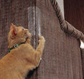 Load image into Gallery viewer, Orange cat scratching clear claw protector pad on brown fabric sofa corner