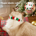 Load image into Gallery viewer, Back view of a cat wearing an elastic Christmas collar with alternating red, green, and white felt balls, showing collar elasticity near a decorated Christmas tree