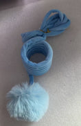 Load image into Gallery viewer, Roll of blue velvet spring material and attached fluffy ball