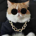 Load image into Gallery viewer, Metallic gold-framed round sunglasses with green mirrored lenses on stone surface