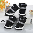 Cargar la imagen en la vista de la galería, Black knit dog booties with white sole and reflective strap displayed on white surface