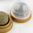 Load image into Gallery viewer, Catnip ball toys in brown plastic bases, one with clear protective dome cover