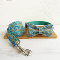 Load image into Gallery viewer, Complete dog collar, leash, and bow tie set with teal floral print displayed on wooden surface