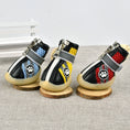 Load image into Gallery viewer, Front view of three colorful breathable dog boots with zippers and paw logo standing on a fabric surface