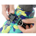 Load image into Gallery viewer, Hands fastening black plastic buckle clasp on dog jacket harness