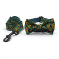 Load image into Gallery viewer, Rolled green jungle print pet leash next to matching bowknot collar with black buckle