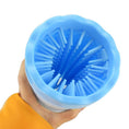 Load image into Gallery viewer, Close-up of blue silicone paw washer bristles inside the cup held in hand