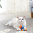 Load image into Gallery viewer, White cat lying on carpet with orange and blue interactive ball toy attached to a feather mouse