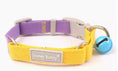 Load image into Gallery viewer, Close-up front view of yellow and purple woven dog collar with release buckle and blue bell