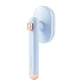 Load image into Gallery viewer, Light blue rotating pet hair removal comb with rose gold accents isolated on white background.