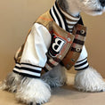 Cargar la imagen en la vista de la galería, Close-up view of dog wearing jacket showcasing the wool plaid texture, letter B patch, and detailed snap buttons