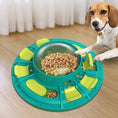 Load image into Gallery viewer, Dog playing with green and teal interactive puzzle toy dispensing kibble on wooden floor