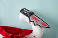 Charger l'image dans la visionneuse de la galerie, Close-up detail of removable bloody knife prop with red splatters and black handle
