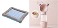 Load image into Gallery viewer, Blue cooling pet bed mat beside pink pet feeder featuring heart shaped handles and food compartment.