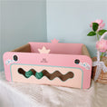 Charger l'image dans la visionneuse de la galerie, Empty pink corrugated cat scratcher bed with heart-shaped cutouts and green balls on table