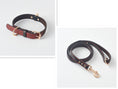 Load image into Gallery viewer, Black PU leather dog collar coiled showing buckle and D-ring
