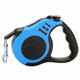 Cargar la imagen en la vista de la galería, Close-up side view of blue automatic retractable dog leash showing ergonomic handle and locking buttons