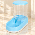 Charger l'image dans la visionneuse de la galerie, Blue gravity pet food dispenser with clear reservoir and white base on pale marble
