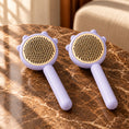 Load image into Gallery viewer, Pack of two purple combs on brown marble