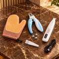 Load image into Gallery viewer, Pet grooming set with white trimmer, blue nail clipper, orange mitt, cable, brush and three button batteries