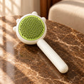 Load image into Gallery viewer, Green and white pet grooming comb with stainless-steel pins on brown marble in a sunlit room.