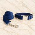 Cargar la imagen en la vista de la galería, Navy velvet collar leash with silver hardware on light ivory-beige marble.