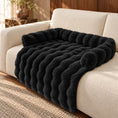 Load image into Gallery viewer, Black plush sofa pet mat with raised bolsters and draped front on a cream sofa