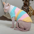 Cargar la imagen en la vista de la galería, Hairless cat wearing a pastel rainbow striped wool sweater sitting with eyes closed